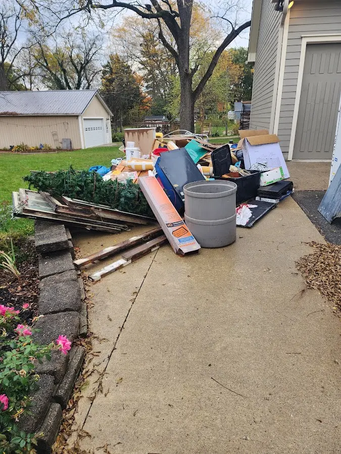 Dumpster being loaded with debris for Commercial Dumpster Rental in Candor
